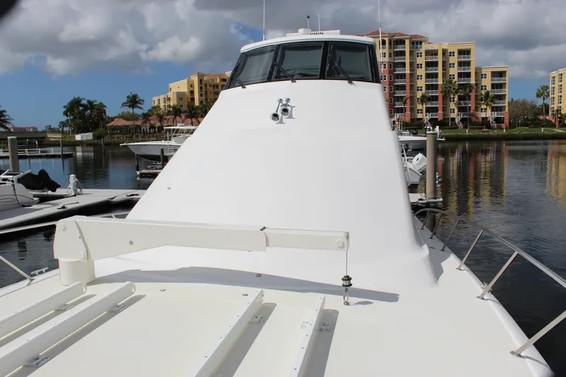 Slide: The Image of 2003 Ocean Yachts 65 Odyssey docked near colorful waterfront buildings. - 22