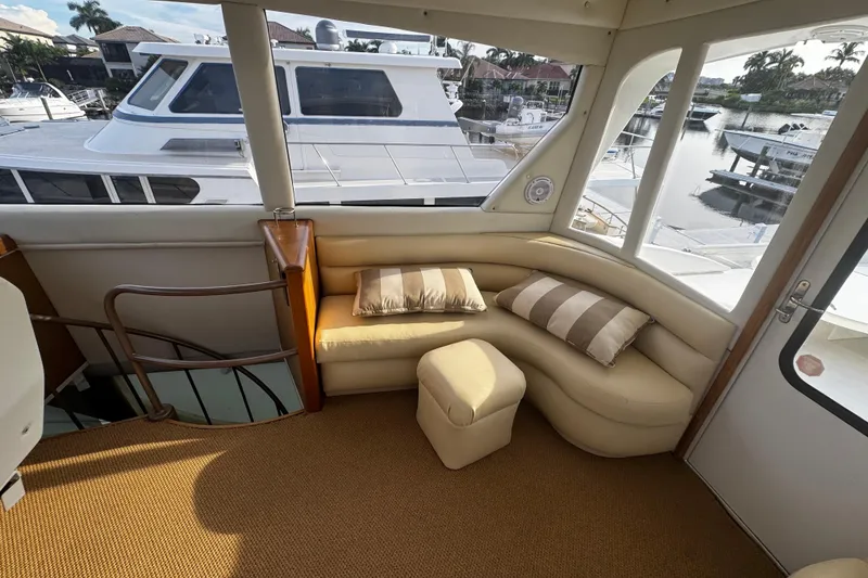 Slide: The Image of Luxurious interior of 2003 Ocean Yachts 65 Odyssey with plush seating and scenic marina view. - 51