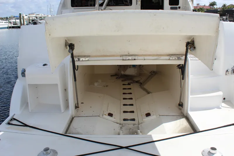 Slide: The Image of Open storage compartment on a 2003 Ocean Yachts 65 Odyssey boat, docked at a marina. - 17