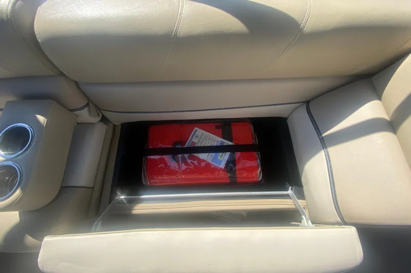 Slide: The Image of Interior storage compartment of 2012 Harris FloteBote Grand Mariner SL 250 with red life jacket. - 30