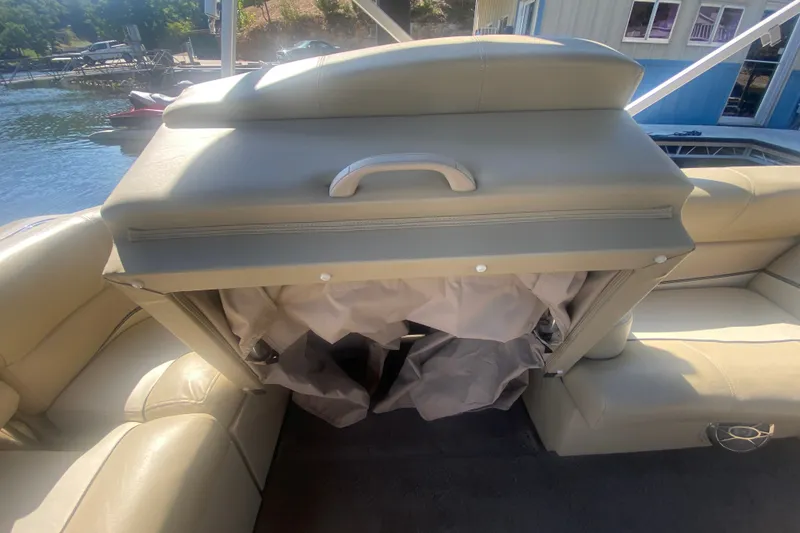 Slide: The Image of 2012 Harris FloteBote Grand Mariner SL 250 interior with beige seating and storage compartment. - 29