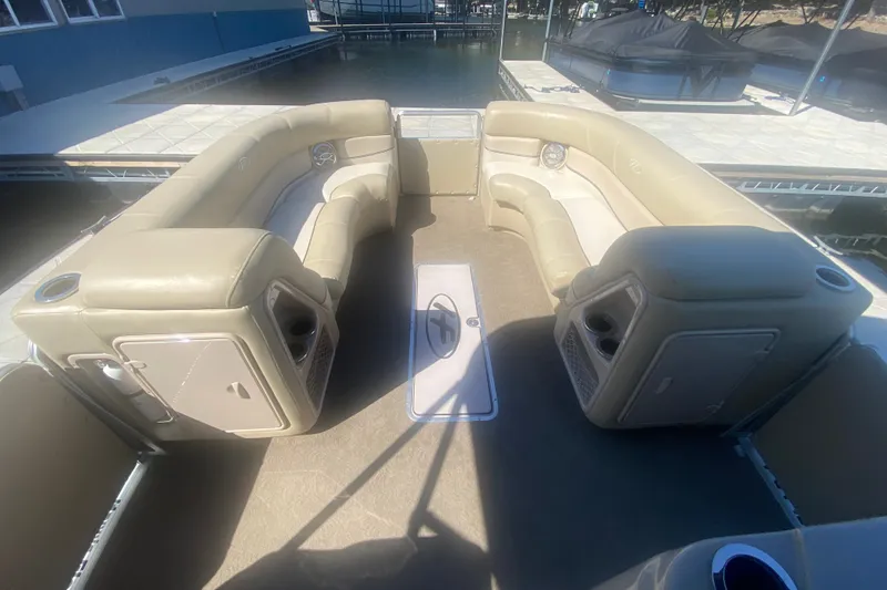 Slide: The Image of 2012 Harris FloteBote Grand Mariner SL 250 interior with beige seating and cup holders. - 28