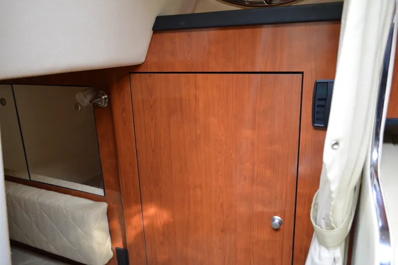 Slide: The Image of Interior cabin of 2007 Sea Ray Sundancer 280 with wood paneling and mirror. - 51