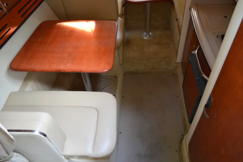 Slide: The Image of Interior of 2007 Sea Ray Sundancer 280 with wooden table and beige seating. - 36