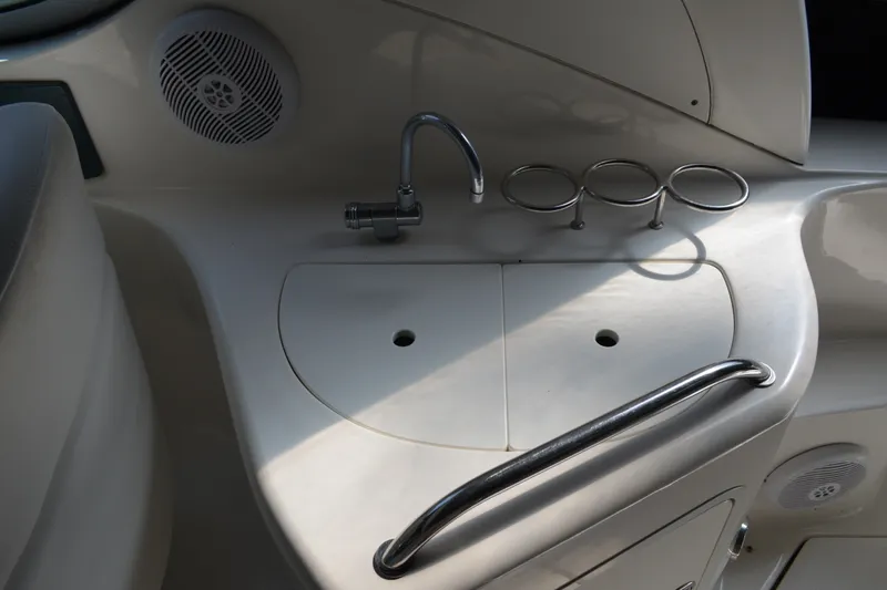 Slide: The Image of 2007 Sea Ray Sundancer 280 boat sink area with faucet and cup holders. - 16