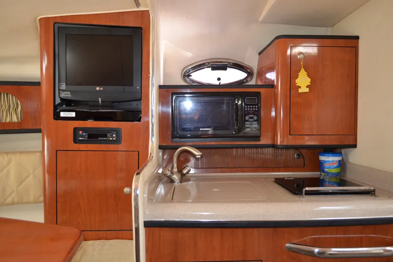 Slide: The Image of 2007 Sea Ray Sundancer 280 interior with TV, microwave, and kitchenette. - 39