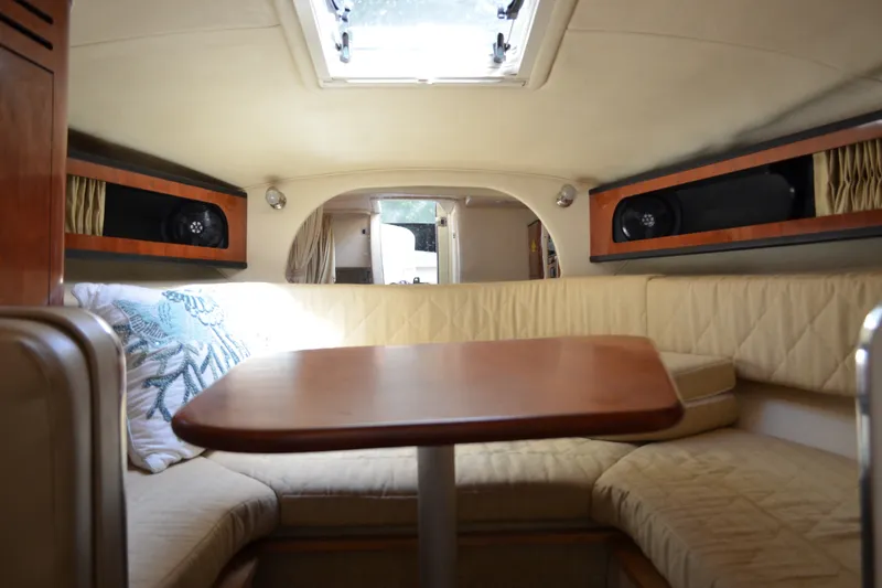 Slide: The Image of Interior of 2007 Sea Ray Sundancer 280 with cozy seating and wooden table. - 41