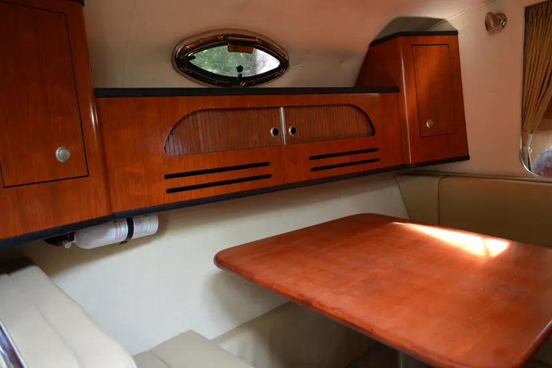 Slide: The Image of Interior of 2007 Sea Ray Sundancer 280 with wooden cabinetry and dining area. - 37