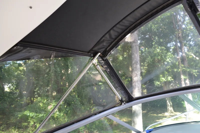 Slide: The Image of 2007 Sea Ray Sundancer 280 canopy detail with forest background. - 22