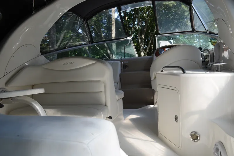Slide: The Image of Interior of 2007 Sea Ray Sundancer 280 boat, featuring sleek white seating and helm. - 13