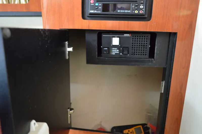 Slide: The Image of Open cabinet on 2007 Sea Ray Sundancer 280 with electronic equipment inside. - 49