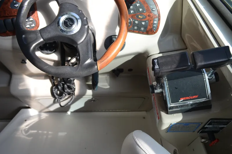 Slide: The Image of 2007 Sea Ray Sundancer 280 helm with steering wheel and Mercury throttle controls. - 28