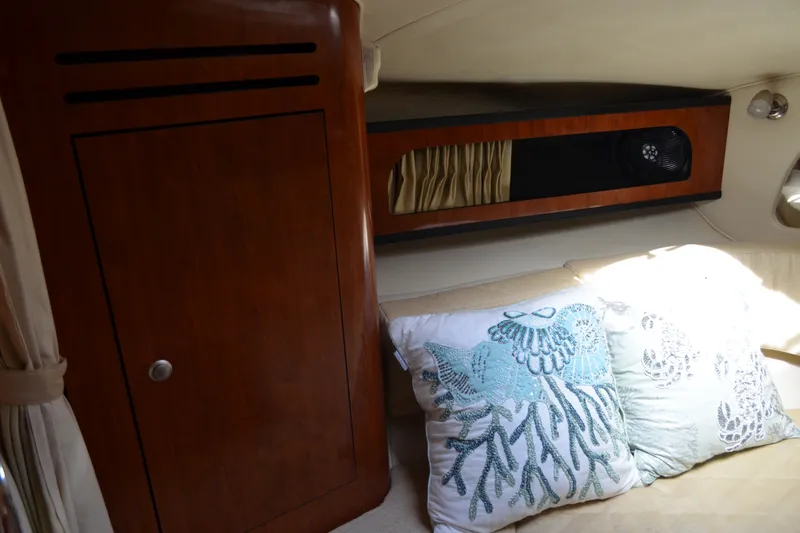 Slide: The Image of Interior of 2007 Sea Ray Sundancer 280 with decorative pillows and wooden cabinetry. - 43