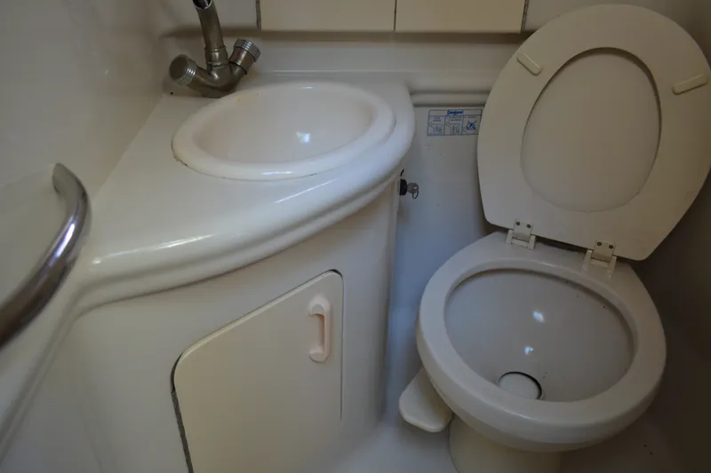 Slide: The Image of Compact bathroom in a 2007 Sea Ray Sundancer 280 boat, featuring a sink and toilet. - 48