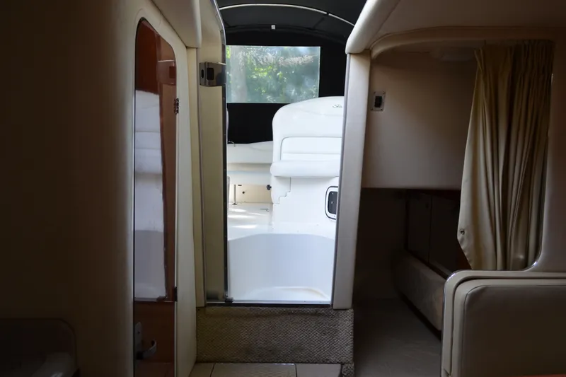 Slide: The Image of Interior view of 2007 Sea Ray Sundancer 280 cabin with open door and curtains. - 44