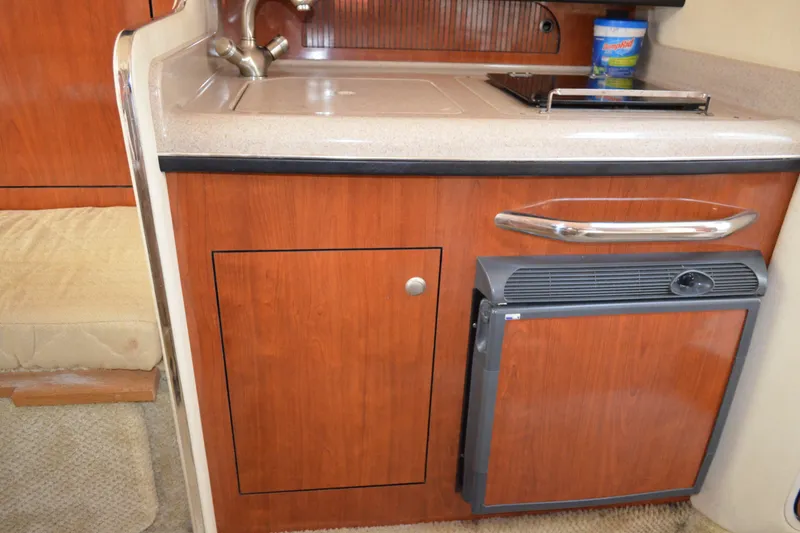 Slide: The Image of 2007 Sea Ray Sundancer 280 interior kitchenette with sink, stove, and mini fridge. - 40
