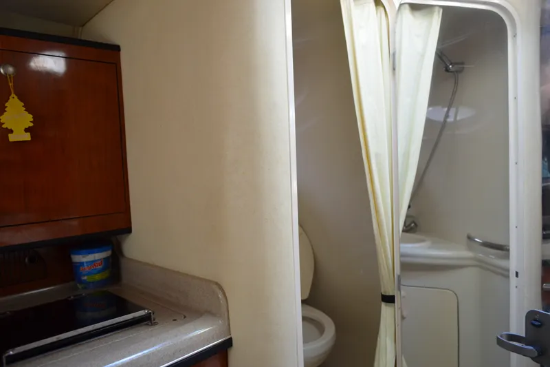Slide: The Image of Interior of 2007 Sea Ray Sundancer 280, featuring compact bathroom and kitchenette area. - 47