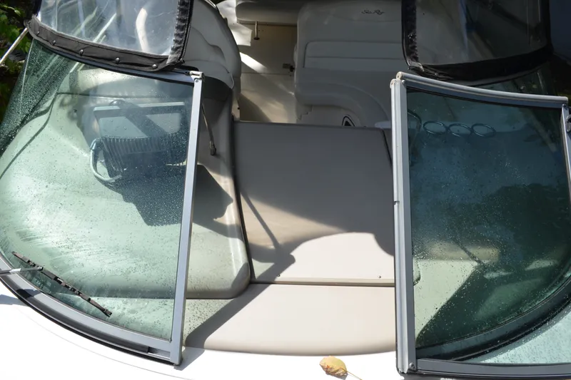 Slide: The Image of 2007 Sea Ray Sundancer 280 boat interior with wet windshield and seating area. - 11