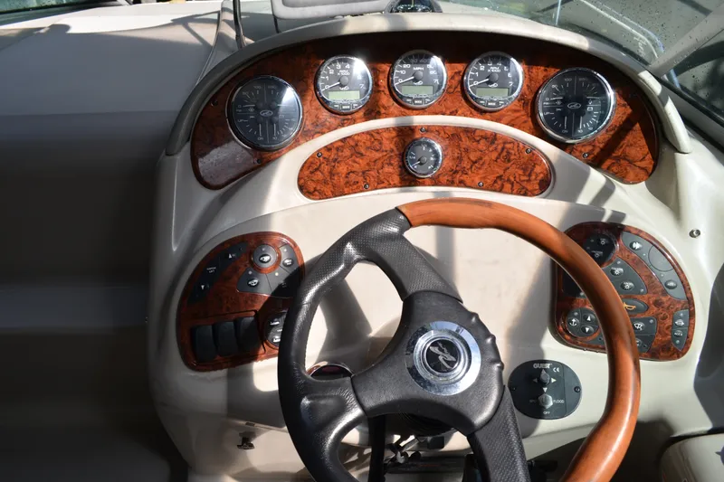 Slide: The Image of 2007 Sea Ray Sundancer 280 dashboard with wood accents and steering wheel. - 27