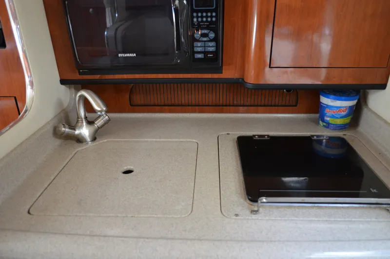 Slide: The Image of 2007 Sea Ray Sundancer 280 galley with sink, stove, and microwave. - 45
