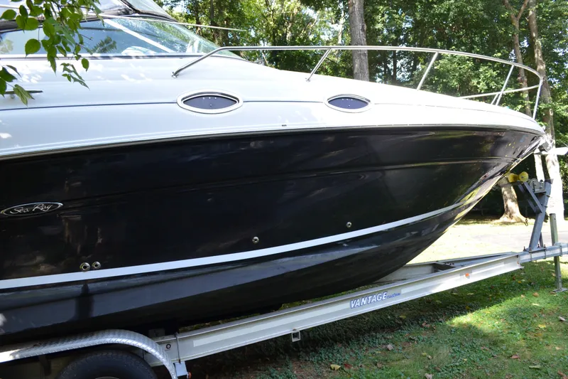 Slide: The Image of 2007 Sea Ray Sundancer 280 boat on trailer, side view with trees in background. - 1