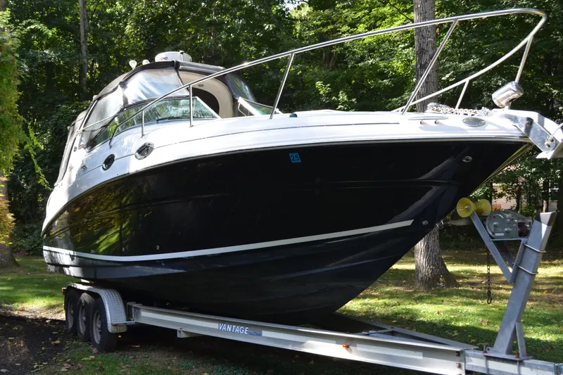 Slide: The Image of 2007 Sea Ray Sundancer 280 boat on trailer in wooded area. - 0