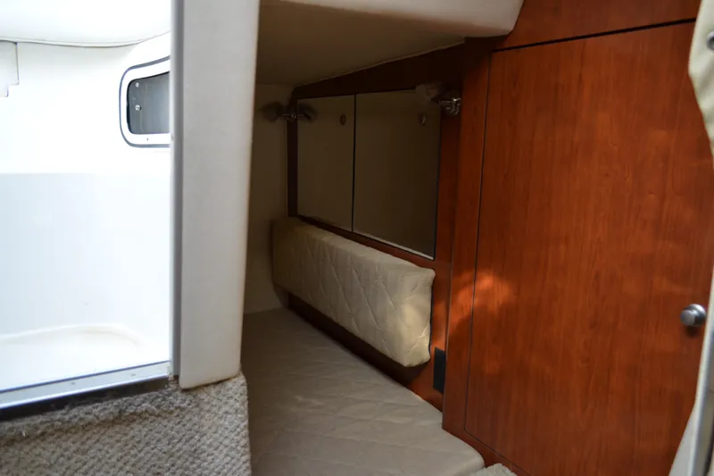 Slide: The Image of Interior cabin of 2007 Sea Ray Sundancer 280 with wood paneling and cushioned seating. - 54