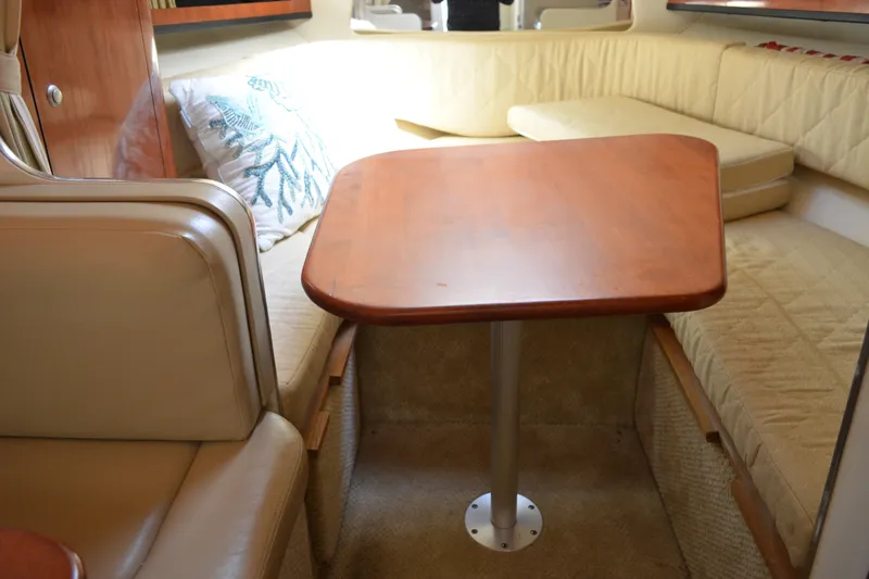 Slide: The Image of Interior of 2007 Sea Ray Sundancer 280 with cozy seating and wooden table. - 38