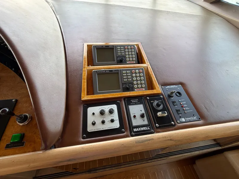 Slide: The Image of The image shows the dashboard of a 1990 Heisley Marine Custom 70 with various control panels. - 38