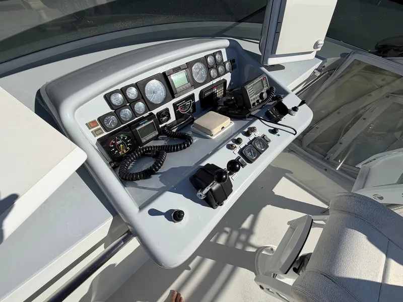 Slide: The Image of The image shows the helm of a 1990 Heisley Marine Custom 70 with various instruments and controls. - 42