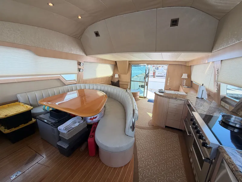 Slide: The Image of Interior of a 1990 Heisley Marine Custom 70 yacht with elegant seating area and modern kitchen. - 14
