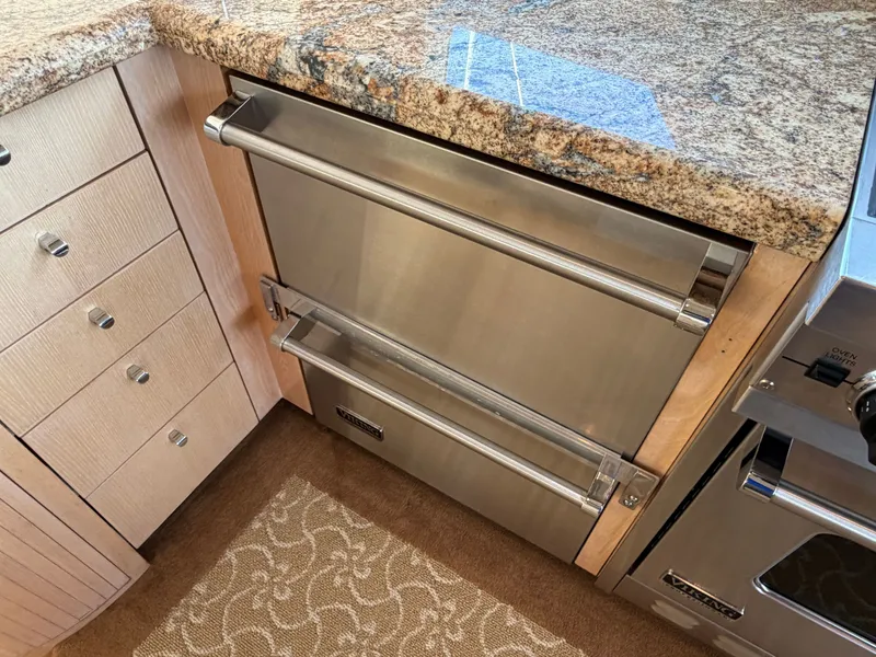 Slide: The Image of A modern kitchen with granite countertop and stainless steel appliances on a Heisley Marine Custom 70 yacht. - 21