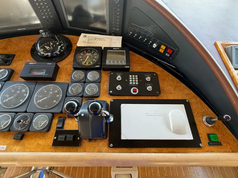 Slide: The Image of The dashboard of a 1990 Heisley Marine Custom 70 with various instruments and gauges. - 39