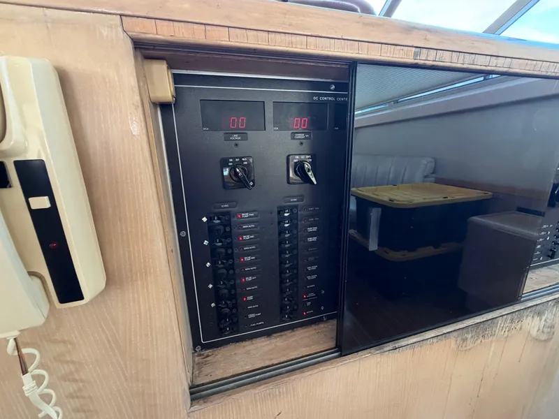Slide: The Image of Electrical control panel on a boat with switches and displays, with a phone mounted on the wall. - 36