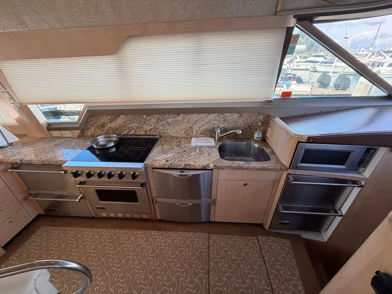 Slide: The Image of The galley of a 1990 Heisley Marine Custom 70 with stove, sink, and microwave. - 15