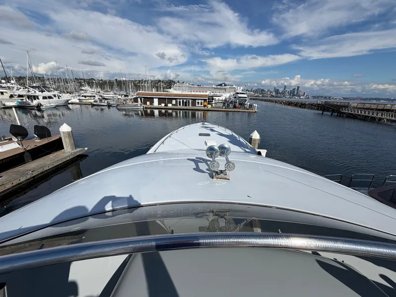 Slide: The Image of A boat in the harbor with a view of the city in the background. - 45