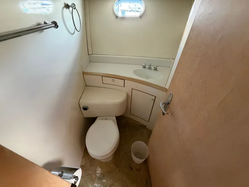 Slide: The Image of The image shows a boat bathroom with a toilet, sink, and small window. - 29