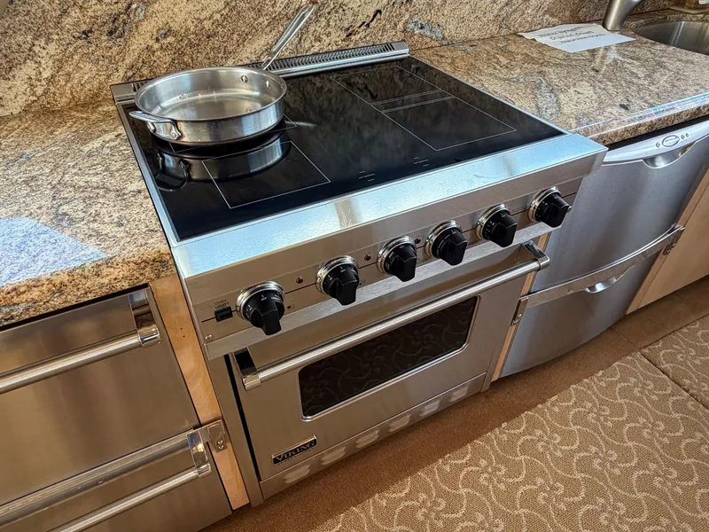 Slide: The Image of A modern kitchen with a stainless steel stove and granite countertop on a boat. - 20