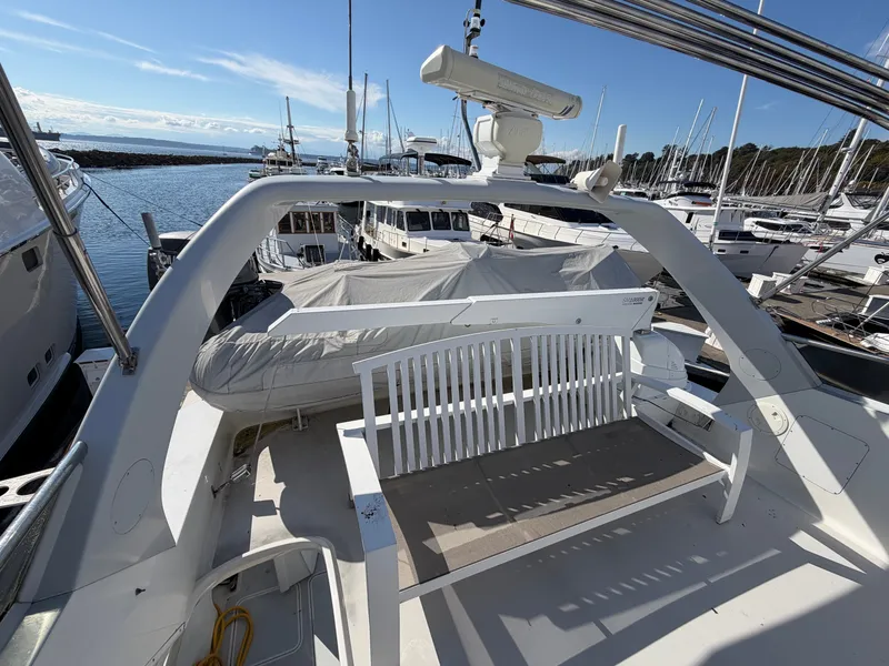 Slide: The Image of The image shows the deck of a 1990 Heisley Marine Custom 70 yacht in a marina. - 41