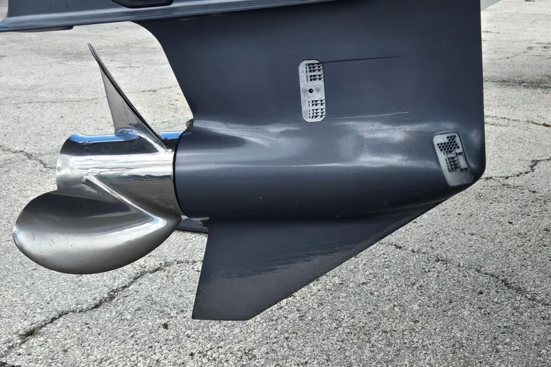 Slide: The Image of 2023 Cobalt 30SC Outboard propeller and lower unit on pavement background. - 26