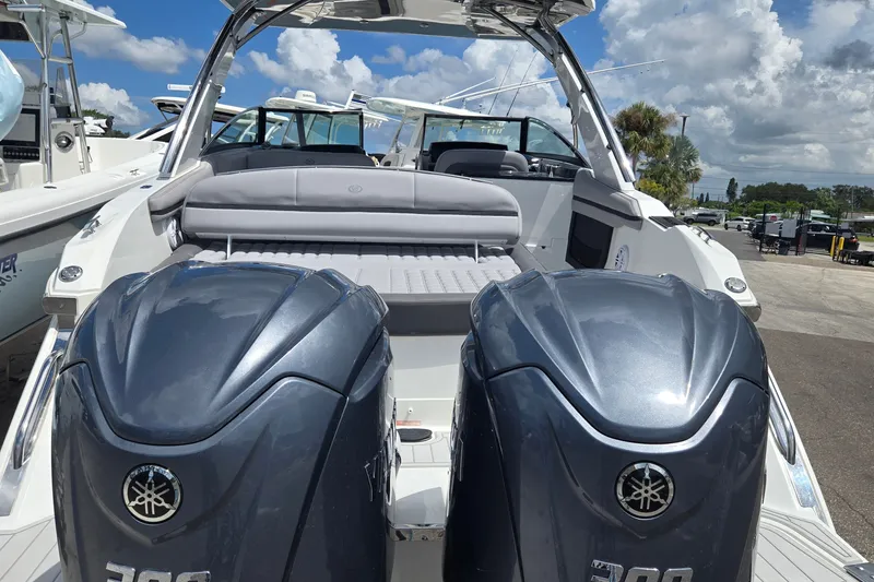 Slide: The Image of 2023 Cobalt 30SC Outboard boat with dual Yamaha engines, docked under a cloudy sky. - 22