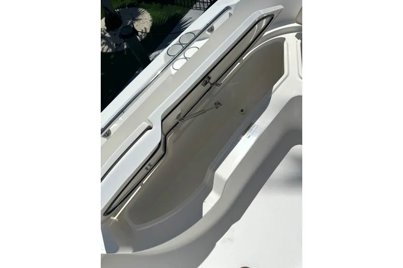 Slide: The Image of 2022 Boston Whaler 270 Dauntless storage compartment, open view, showcasing interior design. - 18