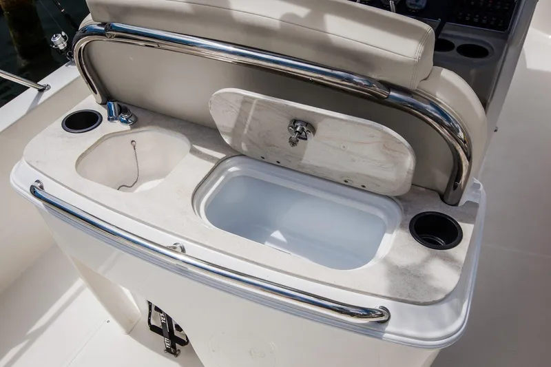Slide: The Image of Manufacturer Provided Image: 2022 Boston Whaler 270 Dauntless boat console with sink and storage compartments. - 12