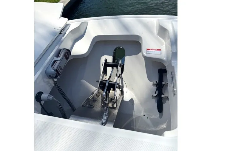 Slide: The Image of 2022 Boston Whaler 270 Dauntless anchor compartment with winch and rope storage. - 15