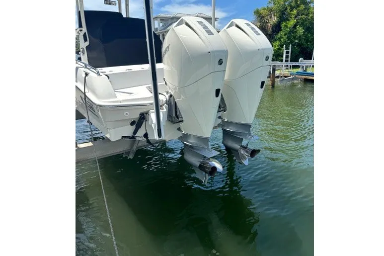 Slide: The Image of 2022 Boston Whaler 270 Dauntless with dual outboard engines on water. - 21