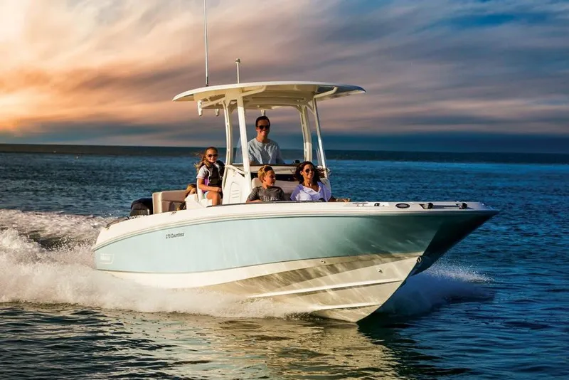 Slide: The Image of Manufacturer Provided Image: 2022 Boston Whaler 270 Dauntless boat cruising on the water at sunset. - 0