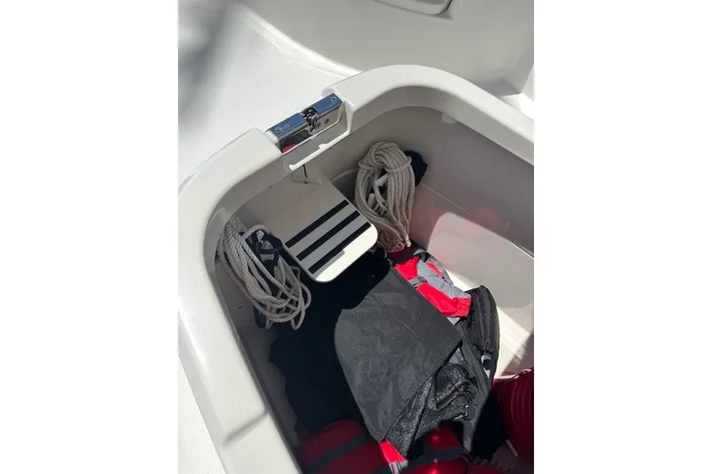 Slide: The Image of Storage compartment of 2022 Boston Whaler 270 Dauntless with ropes and gear. - 17