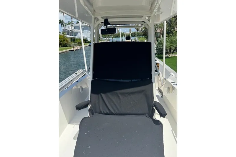Slide: The Image of 2022 Boston Whaler 270 Dauntless boat interior with black seating, dockside view. - 24