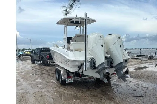 Slide: The Image of 2022 Boston Whaler 270 Dauntless boat on trailer, parked near waterfront. - 32