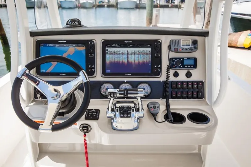 Slide: The Image of Manufacturer Provided Image: 2022 Boston Whaler 270 Dauntless boat dashboard with navigation and control systems. - 9